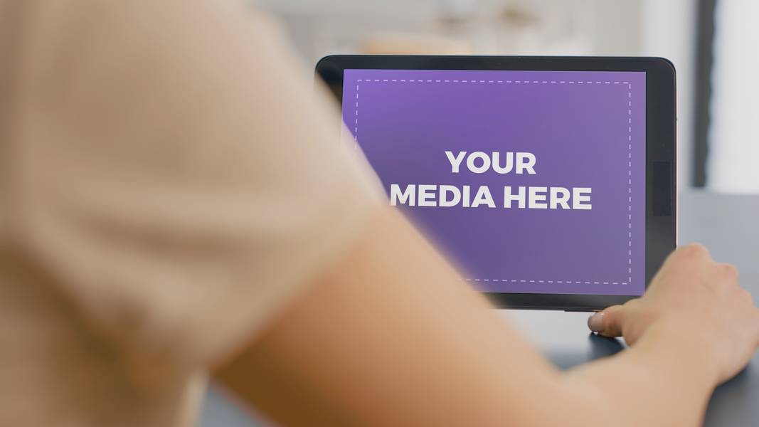 Woman holding tablet in office landscape